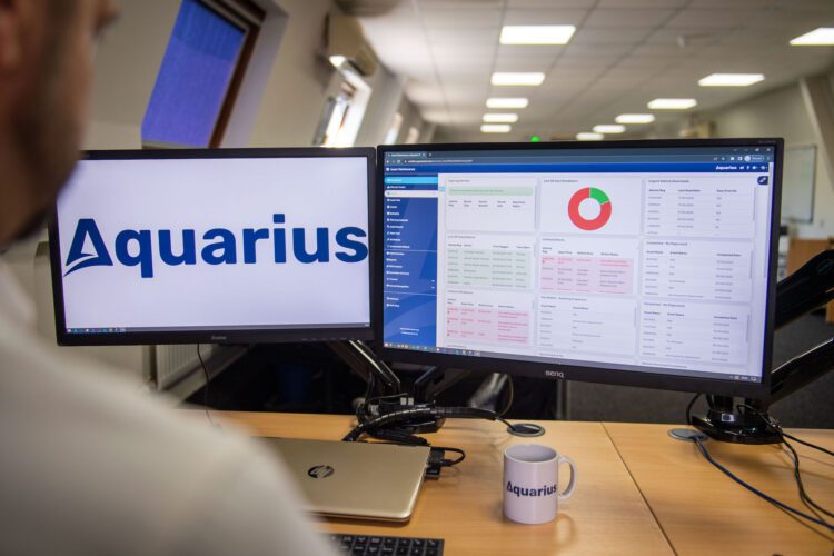 Computer In Office With The Aquarius Asset Maintenance Dashboard