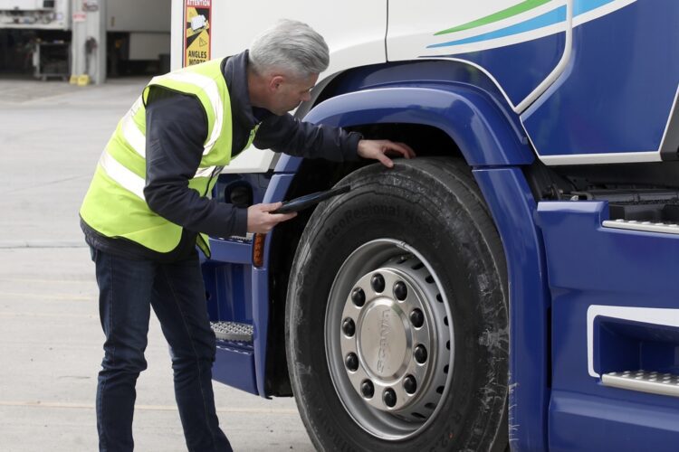 Fleet Operator Checking Tires For Asset Maintenance