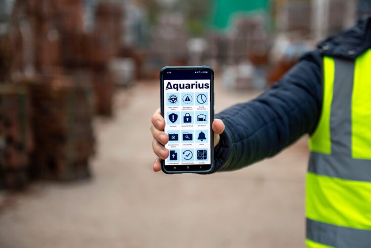 Man Holding Phone With The Aquarius IT App
